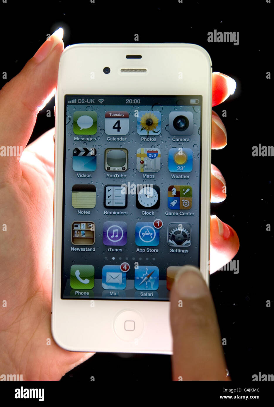 An apple employee demonstrates the latest apple product the iphone 4s