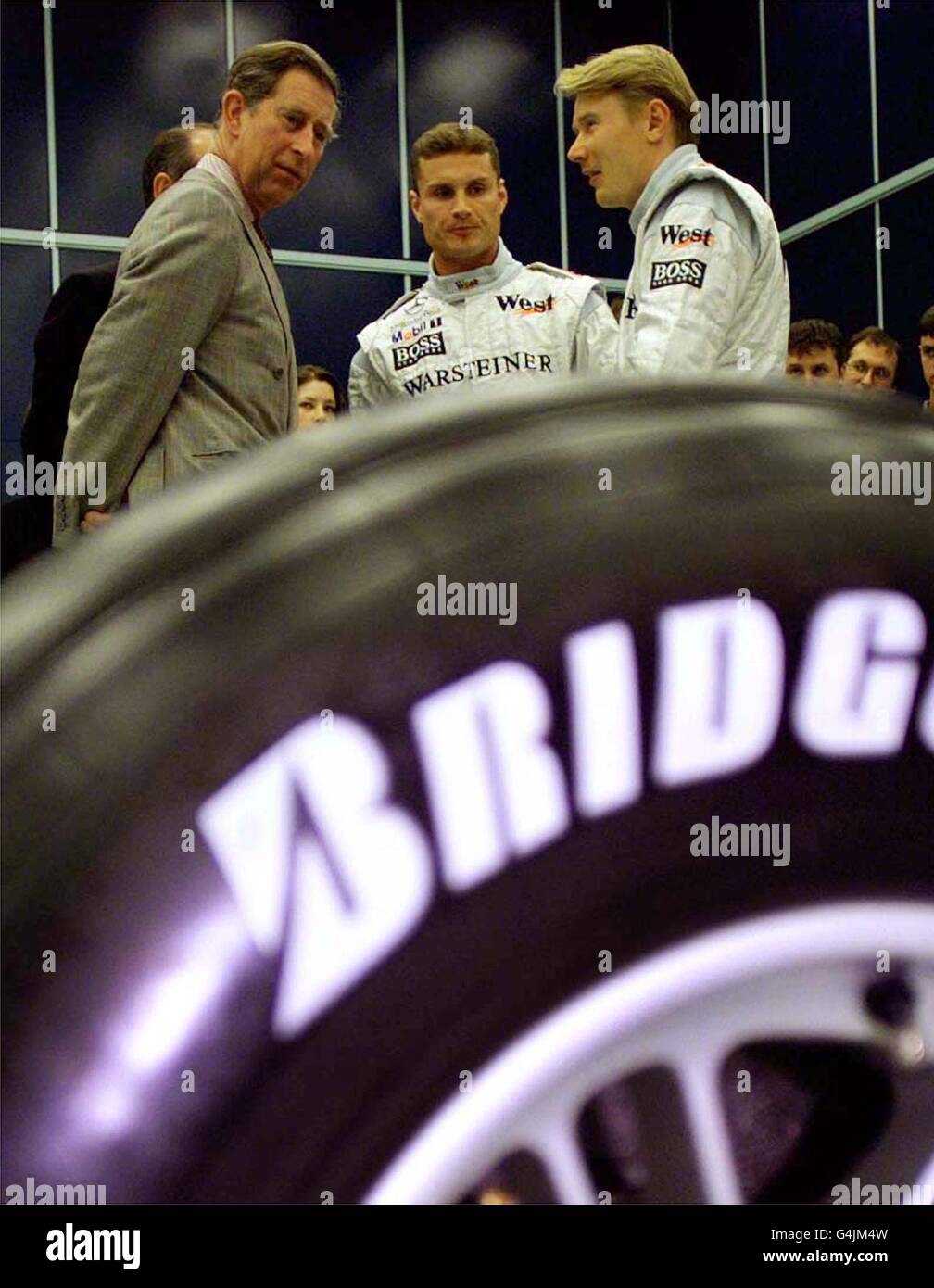 The Prince of Wales (left) talks to 1998 Formula One Champion Mika Hakkinen (right) and his team mate David Coulthard, during a visit to the Woking based Mclaren factory today (Wednesday). PA Photos (Reuter Rota Pic) Stock Photo
