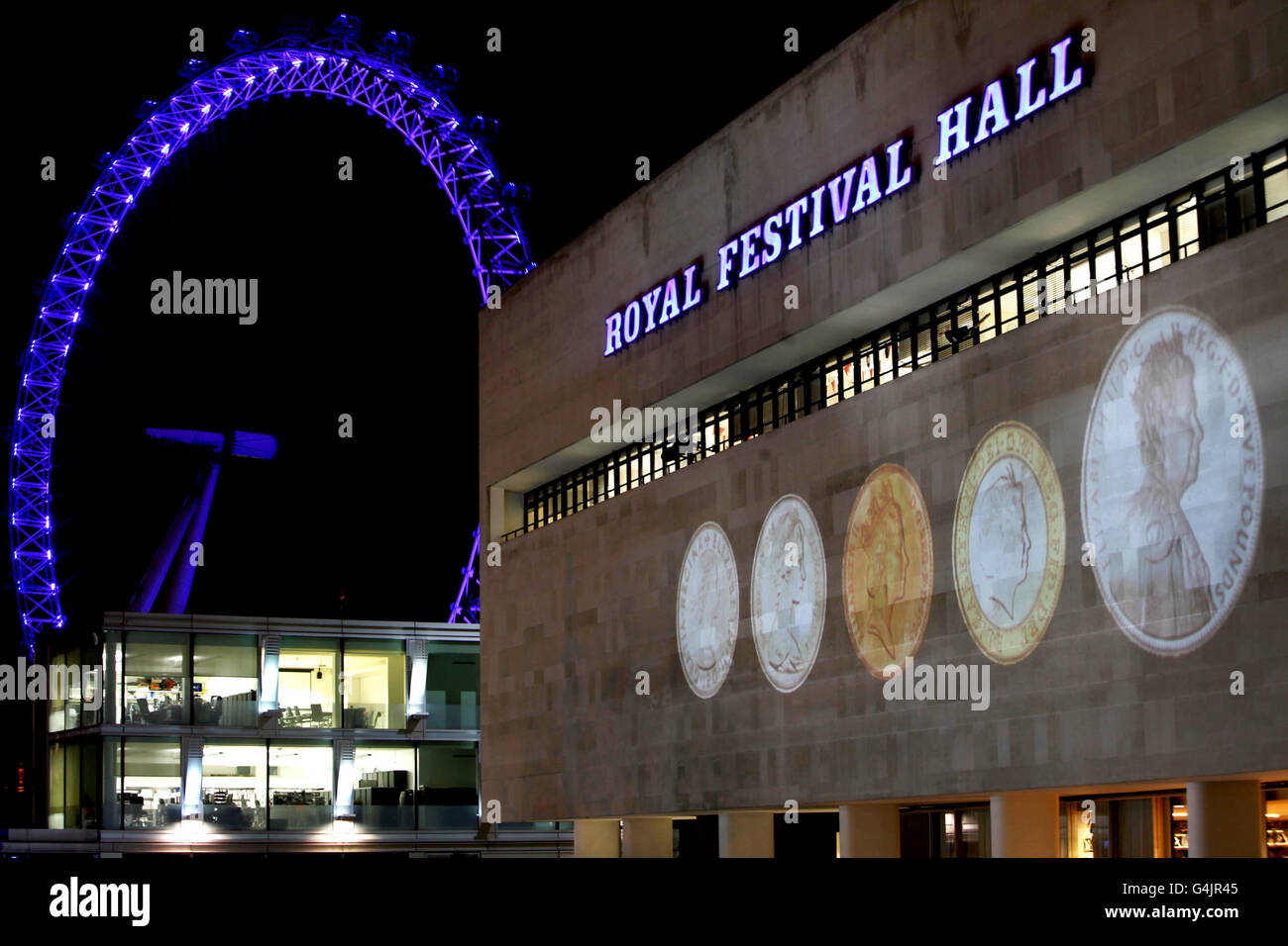 An image of the only official UK 5 coin (right) commemorating The Queen's Diamond Jubilee alongside four coin portraits of The Queen from 1953, 1968, 1985 and 1998, is projected on to the Royal Festival Hall in London. Stock Photo