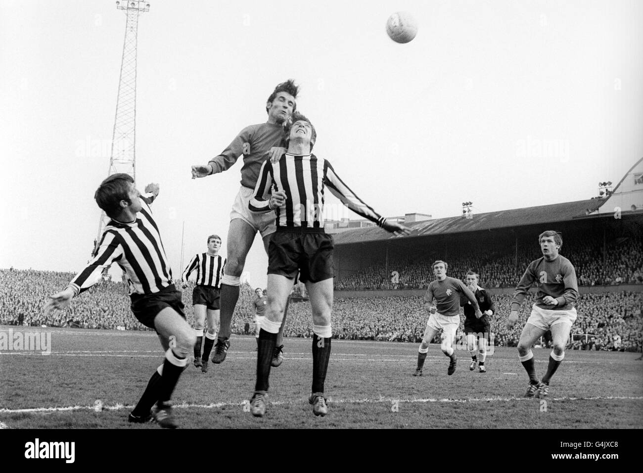 Rangers' Ronnie MacKinnon beats Newcastle United's Wyn Davies to the header. Newcastle went on to win the match 2-0 and eventually the 1968-1969 Inter-Cities Fairs Cup. Stock Photo