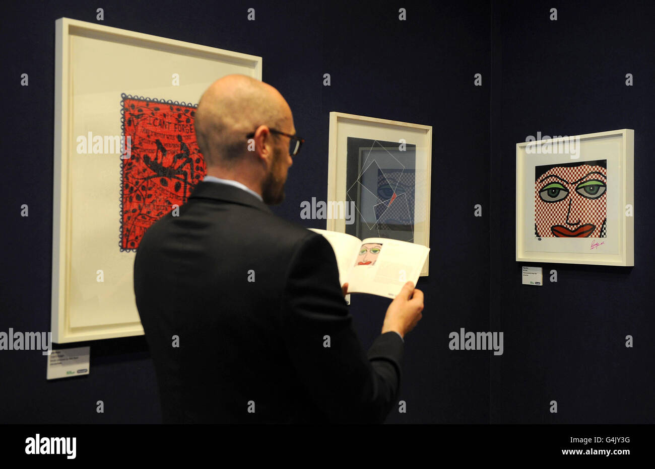 Bonhams senior specialist in contemporary art Alan Montgomery, looks at number of art works including Ringo Starr's 'Oky Doky', which are to be auctioned at Bonhams for Macmillan De'Longhi art auction in aid of Macmillan Cancer Support tomorrow. Stock Photo