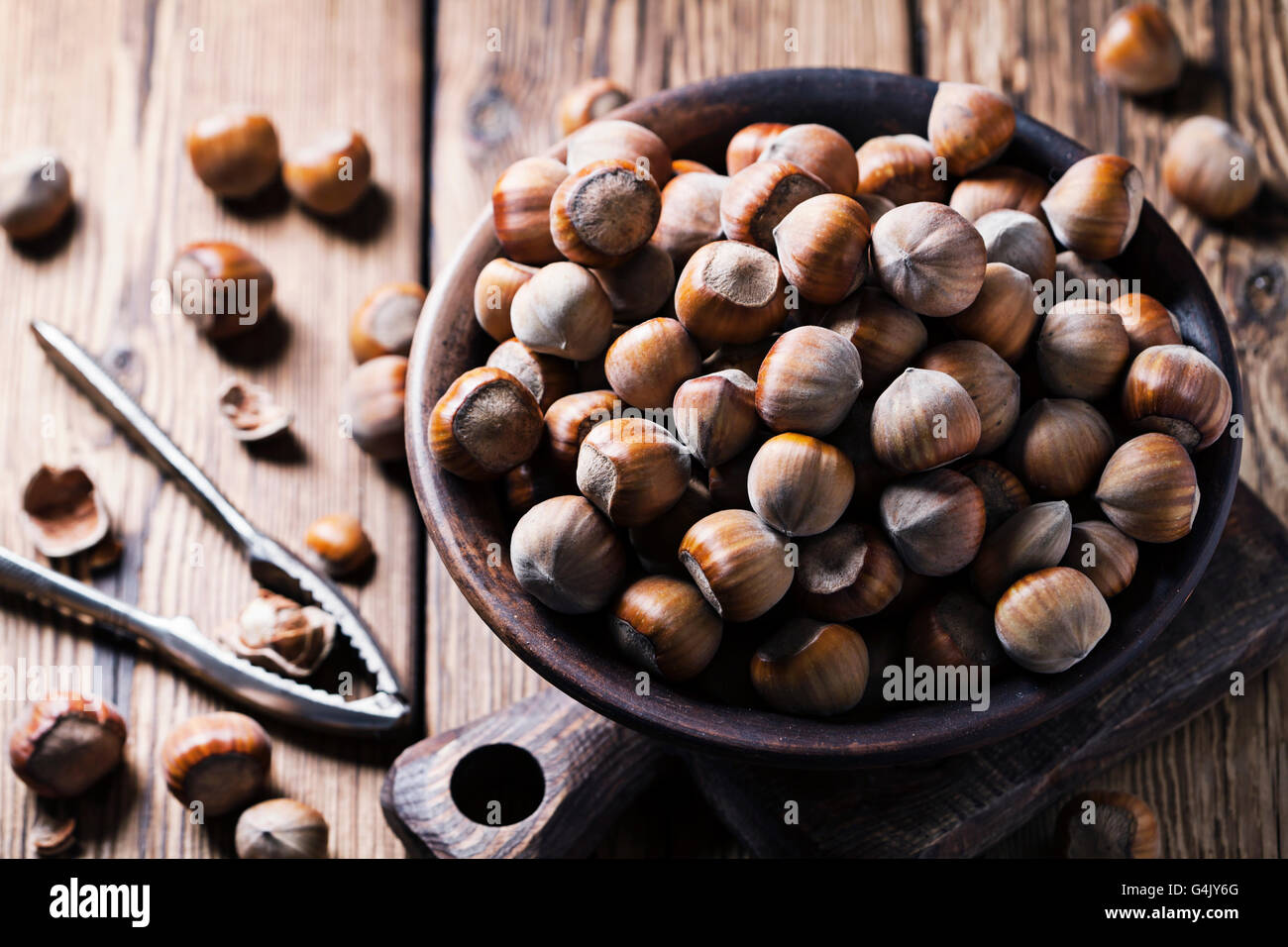 Hazelnuts on a bowl on woden background Stock Photo