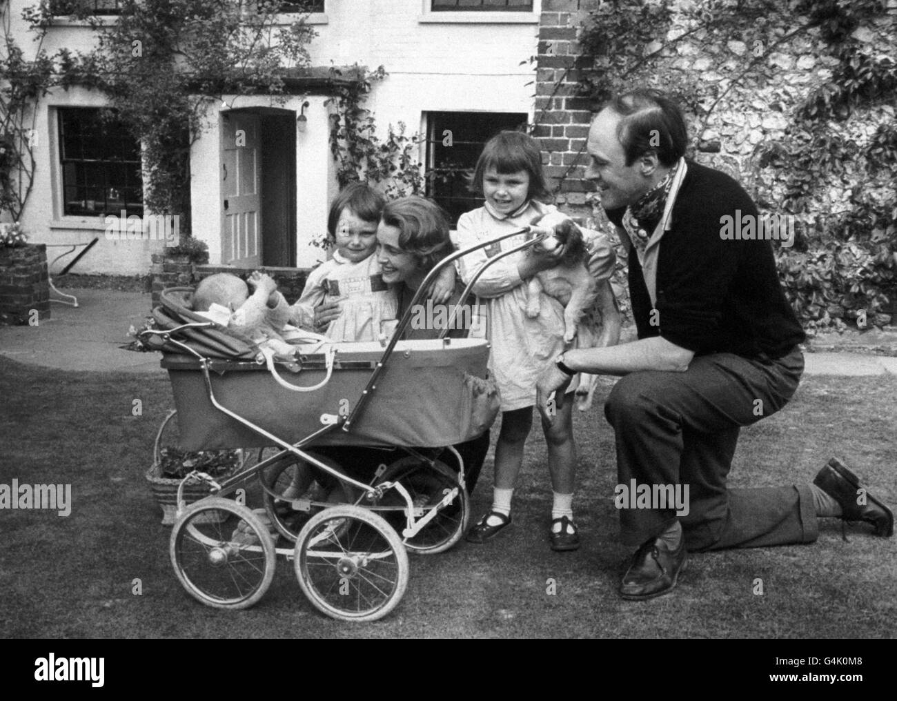 A family photograph of the children's author Roald Dahl, with his wife Patricia Neal, and children Olivia (right) Tessa, and Theo (in pram). Stock Photo