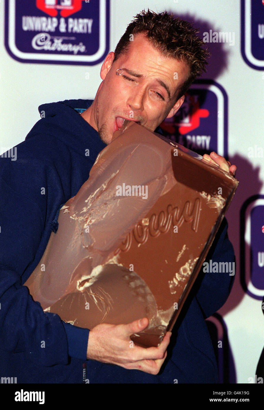 Jason Brown from the boy band Five, who tucked into the largest bar of Cadbury's Dairy Milk chocolate ever made at an MTV Select photocall in London to announce a secret pop event to be staged by the daily pop show later in the year. Stock Photo