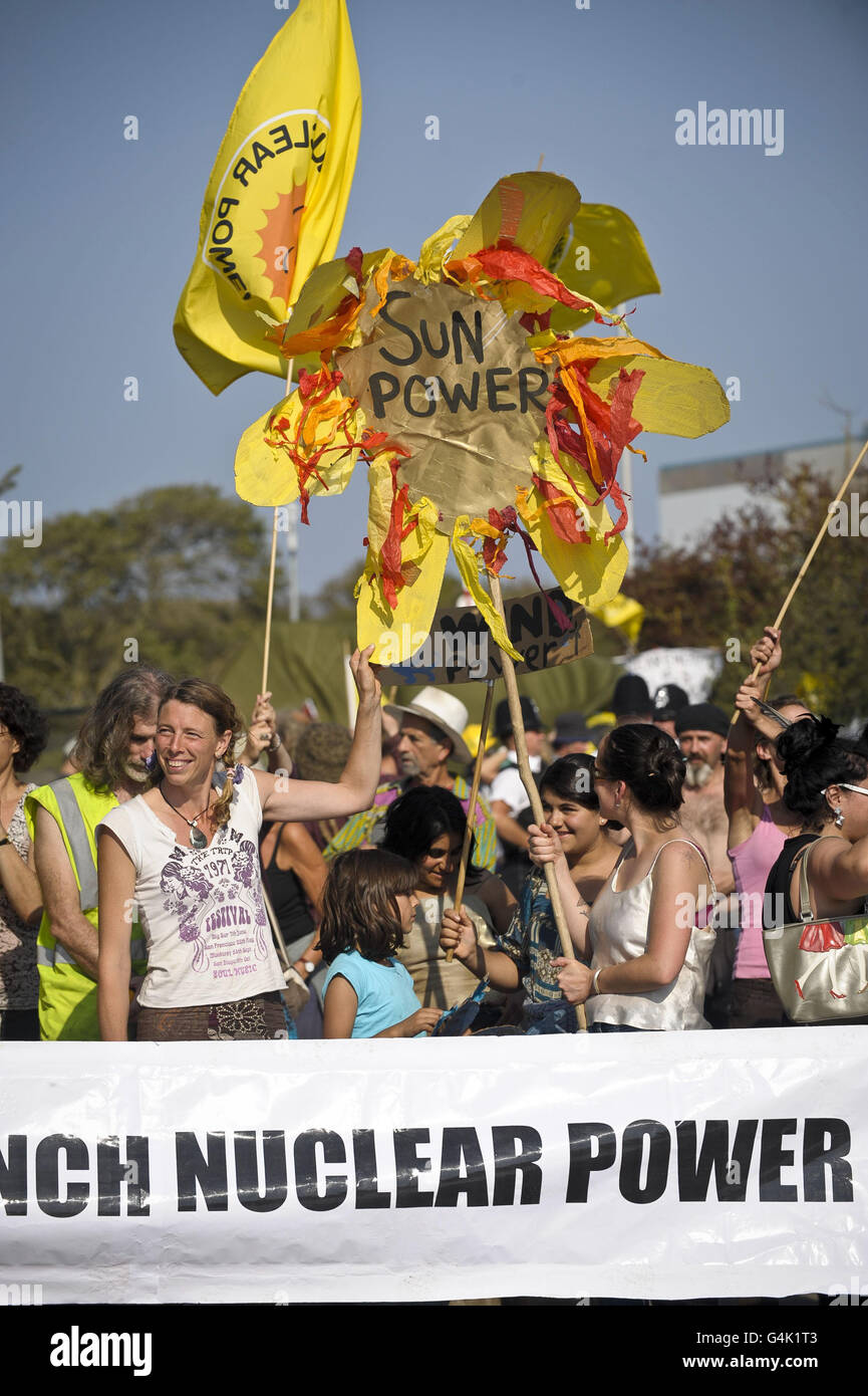 Protestor hold banners outside Hinkley Point power station in Somerset as several anti-nuclear groups who are part of the Stop New Nuclear alliance protest against EDF Energy's plans to renew the site with two new reactors. Stock Photo