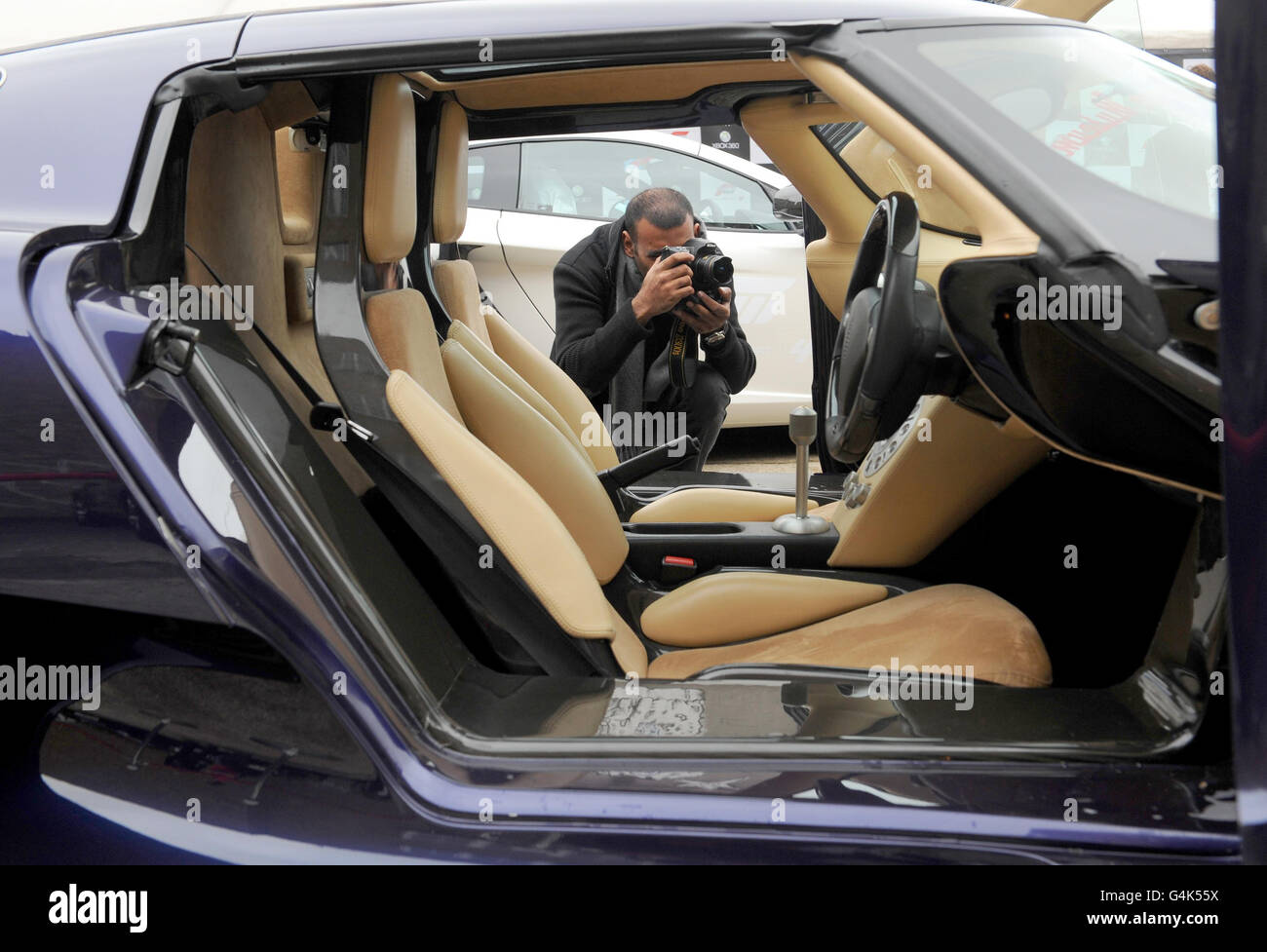 Path Ruthirapathy photographs the interior of a Koenigsegg CCX, one of a number of supercars at the launch of Forza Motorsport 4 game for Xbox 360, in Shoreditch, east London. Stock Photo