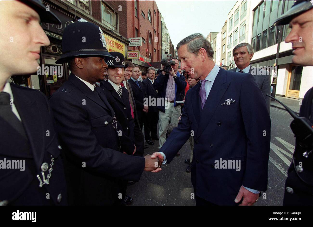 The Prince of Wales shakes hands with one of the first police constables to arrive at the scene of the nail bomb blast in the Admiral Duncan pub on April 30 1999, in which three people were killed and at least 72 were injured. Stock Photo