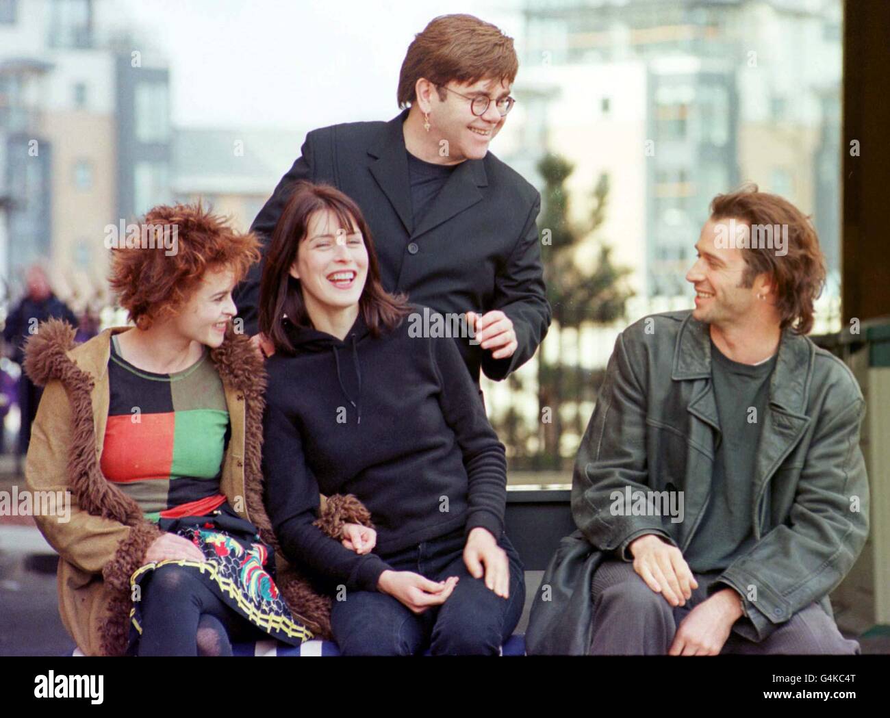 The cast of 'Women Talking Dirty' take a break in filming to meet the press in Edinburgh after filming. Actresses Helena Bonham Carter (L) & Gina McKee look on as pop star Elton John shares a joke with actor James Purefoy (R). Stock Photo
