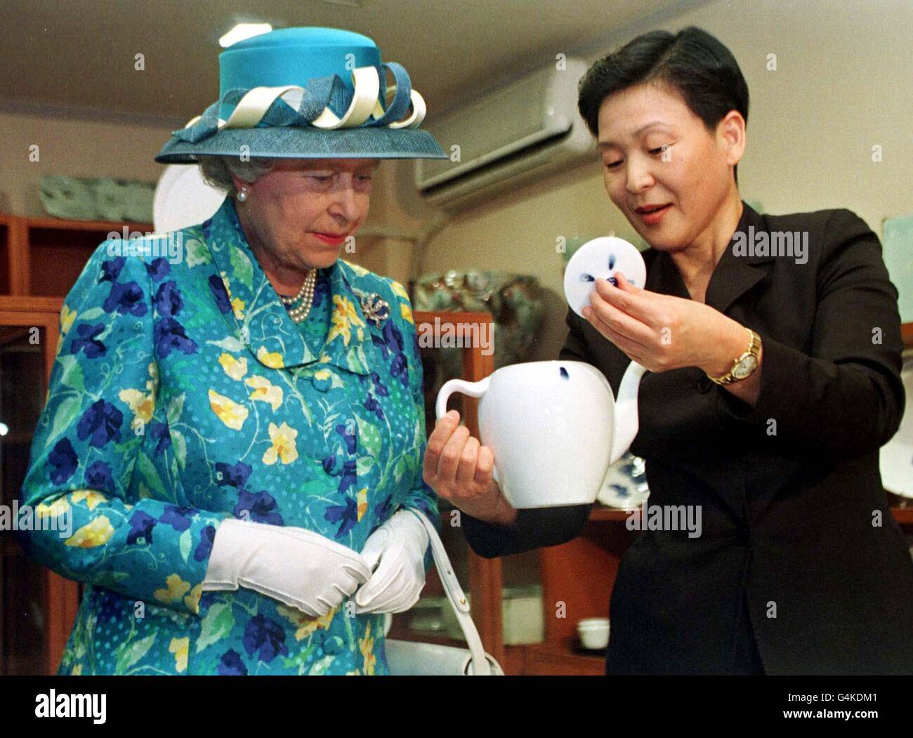 The Queen is shown a celadon teapot, during a visit to a pottery shop in Seoul, South Korea. Celadon is a grey-green glaze used on pottery. The Queen and Duke of Edinburgh arrived in Seoul 19/04/99 for a four-day state visit, the first by a British monarch. Stock Photo
