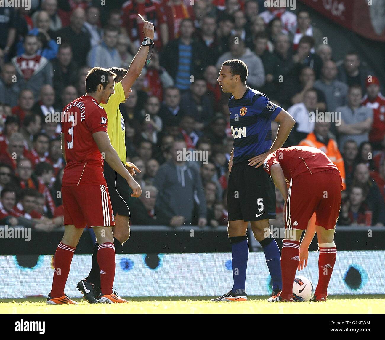 Manchester United's Rio Ferdinand (centre right) is booked by match referee Andre Marriner (obscured) Stock Photo