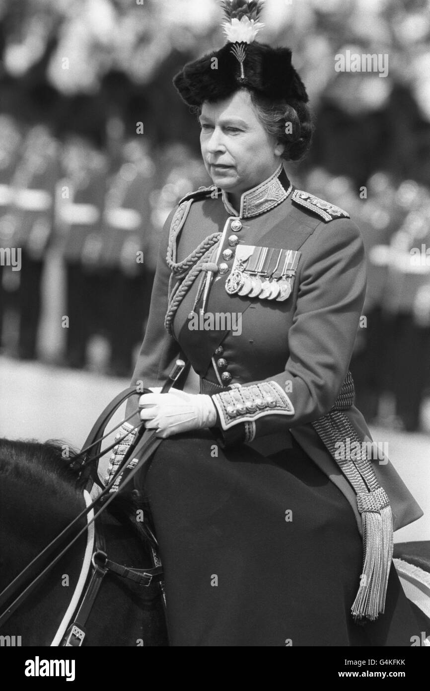 The Queen, tense and shaken after a man fired several blanks from a replica pistol as the she passed in The Mall, rides into Horseguards Parade for the Trooping the Colour Ceremony. The man was later named as Marcus Simon Sarjeant, of Folkestone, Kent. Stock Photo