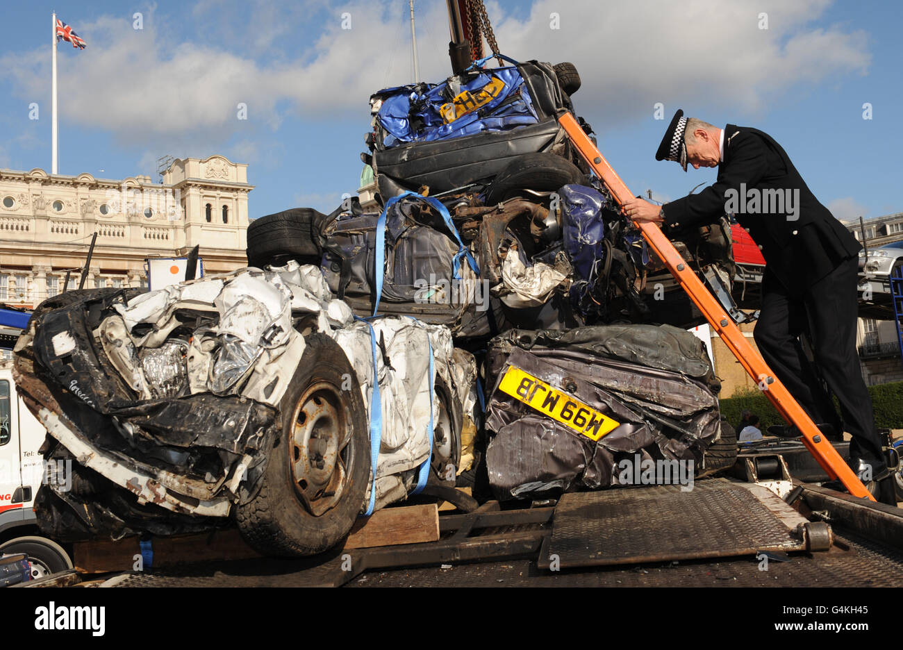Metropolitan Police Commissioner Bernard Hogan-Howe with a collection of crushed cars as a result of them being uninsured, on Horse Guards Parade in London today. Stock Photo