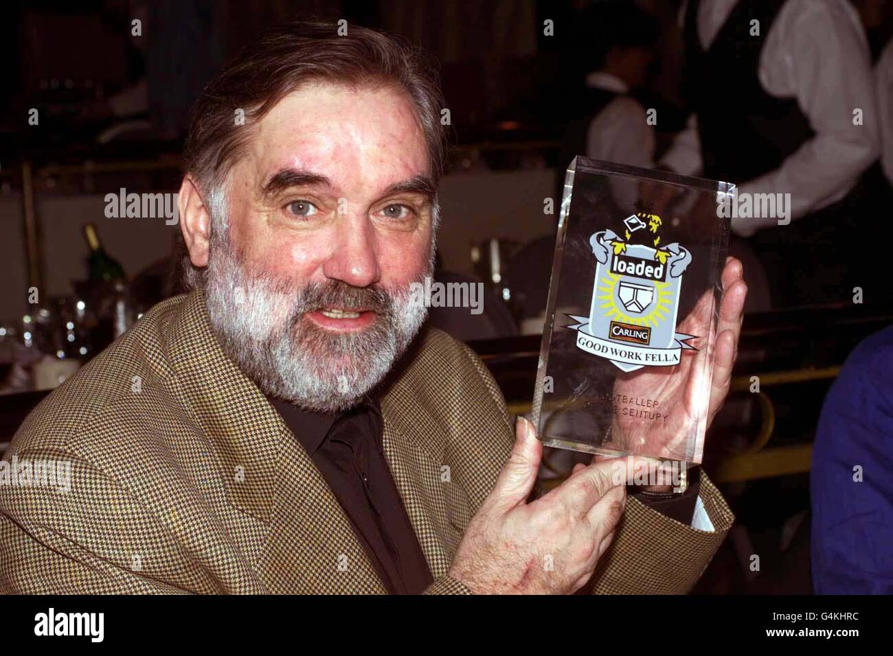 George Best with his award for Footballer of the Century at the Loaded awards held at the Talk of the Town in London. Stock Photo