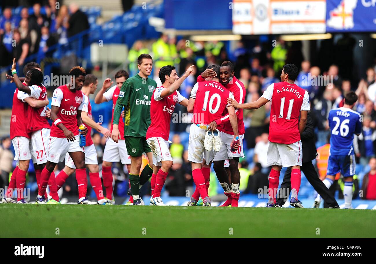 Arsenal players celebrate victory after the final whistle as Chelsea's John  Terry (far right) trudges off the pitch dejected Stock Photo - Alamy