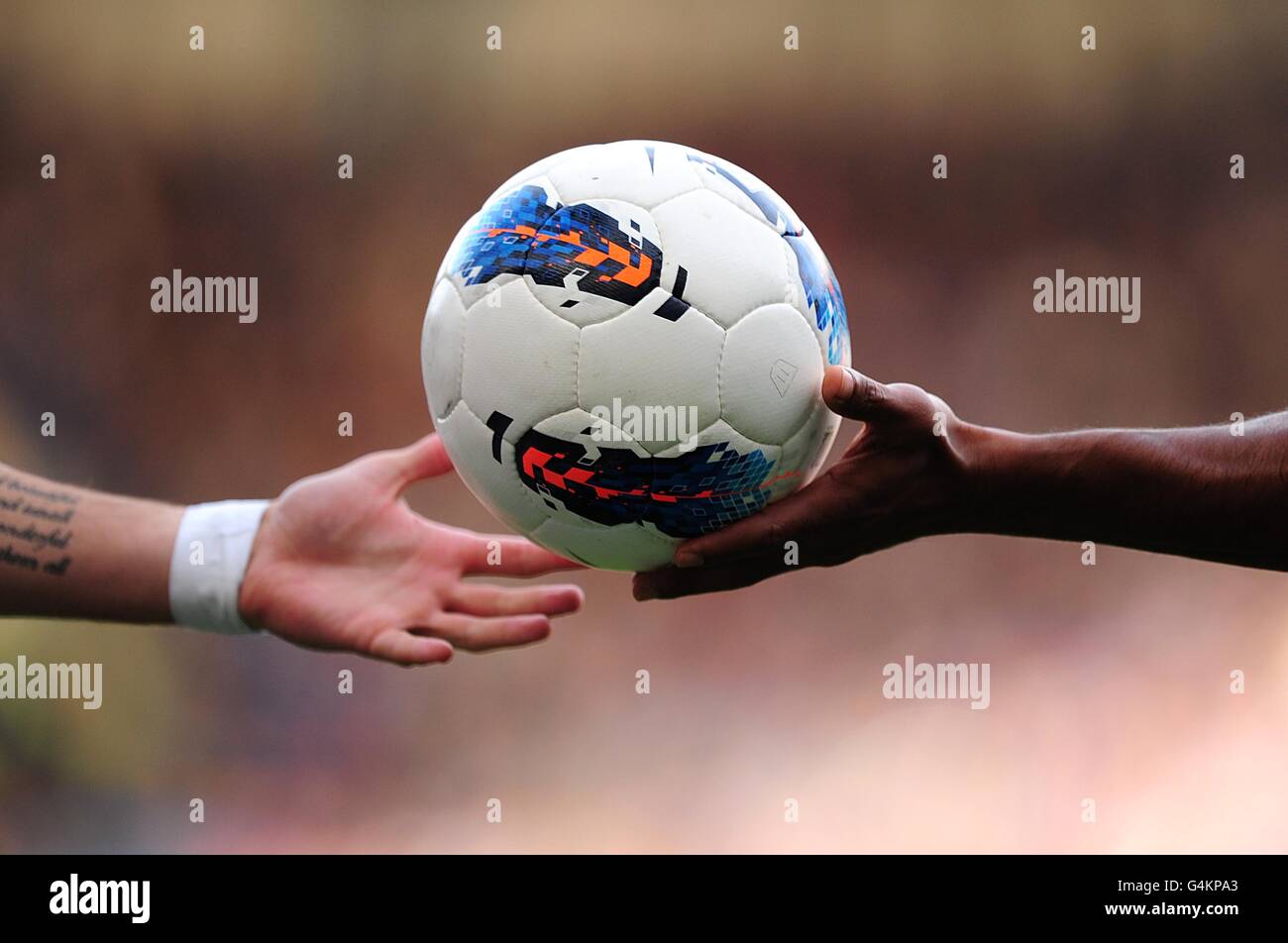 A generic view of a player holding the match-ball out to give it to another player from the opposing team Stock Photo