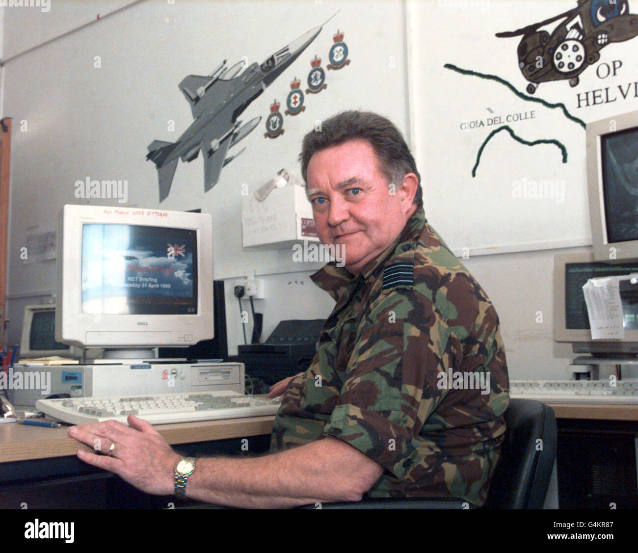 Wing Commander Bill McQueen, the Royal Air Force's meteorological officer at Gioia del Colle, southern Italy, at his desk as he prepares to brief Harrier pilots from No 1 Squadron on the weather condition they will meet during a sortie over Kosovo. * As head of the mobile meteorological unit at the base, he heads a round-the-clock operation which, using satellite imagery and other data, keeps a detailed eye on current conditions and forecasts for the region. Wing Cdr McQueen, who is based at RAF Benson, near Oxford, said: Simply, our job is to make sure the pilots are never surprised by any Stock Photo