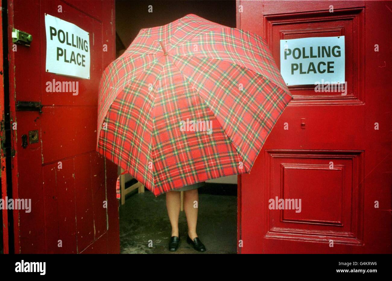 A voter braves the weather at a polling station at St Stephen's church in Edinburgh, to select the first Scottish Parliament for 300 years. Elsewhere in the United Kingdom, voters in Wales were choosing members of a new Welsh assembley. Stock Photo