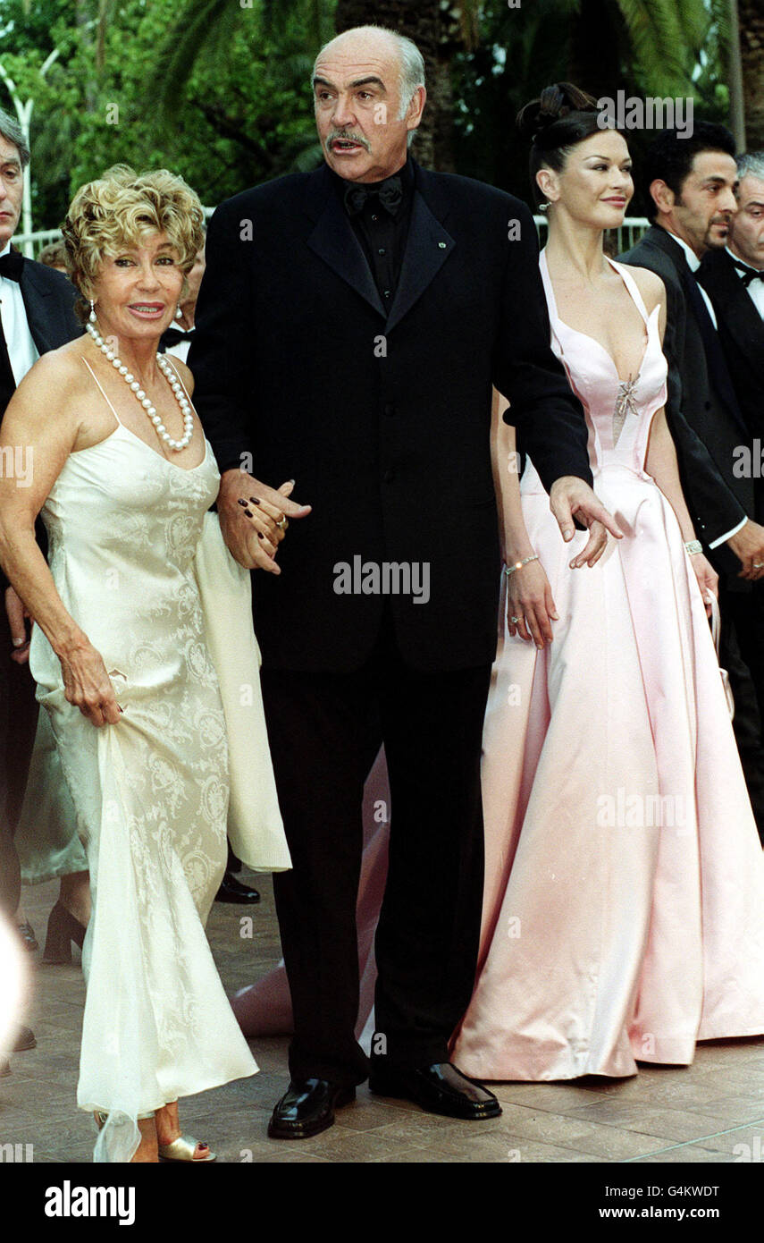 Actors Catherine Zeta-Jones (right) and Sean Connery, with his wife Michelina, arrive at the Palais des Festivals for the movie premiere of 'Entrapment' during the 1999 Cannes Film Festiva in France. Stock Photo