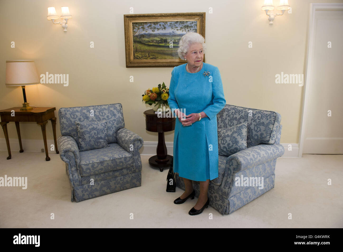 Queen Elizabeth II stands in a room in Government House, Canberra