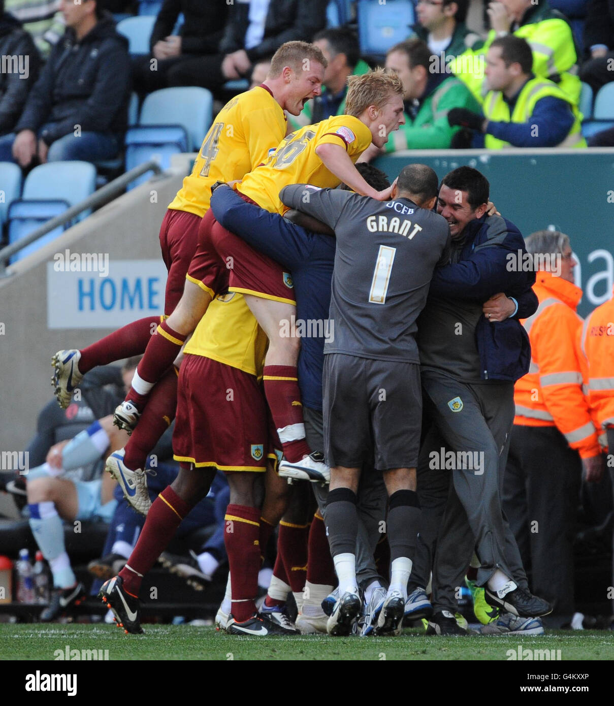 Burnley's players celebrate with Charlie Austin (hidden) after his winning goal during the npower Football League Championship match at the Ricoh Arena, Coventry. Stock Photo