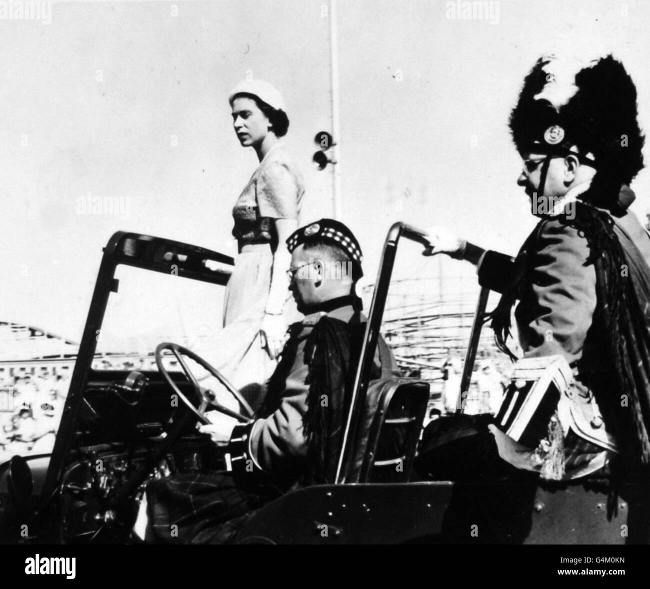 queen-elizabeth-ii-standing-in-a-jeep-in