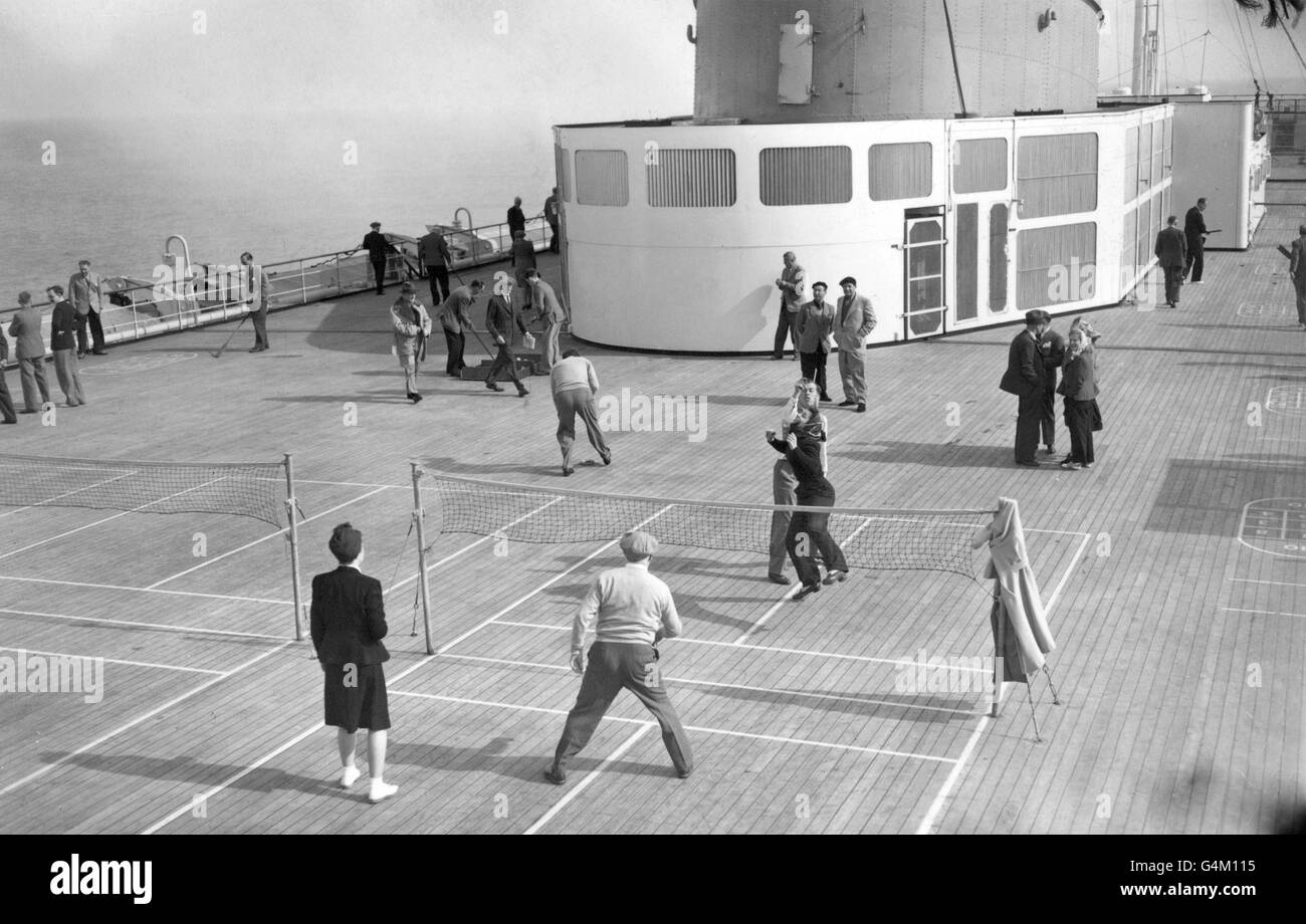 Passengers on the RMS Queen Elizabeth enjoy the Sports Deck during the Atlantic crossing. The deck extends the entire width of the great ship. *Damaged Negative* Stock Photo