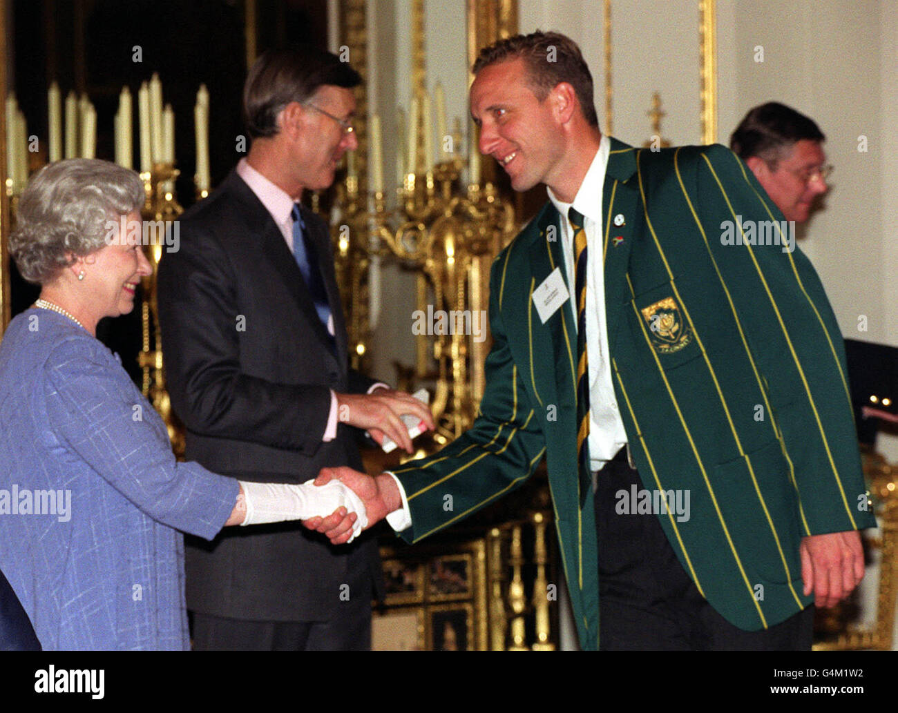 The Queen shakes hands with South African cricketer Allan Donald during a reception at Buckingham Palace in London for the World Cup cricket teams. Stock Photo