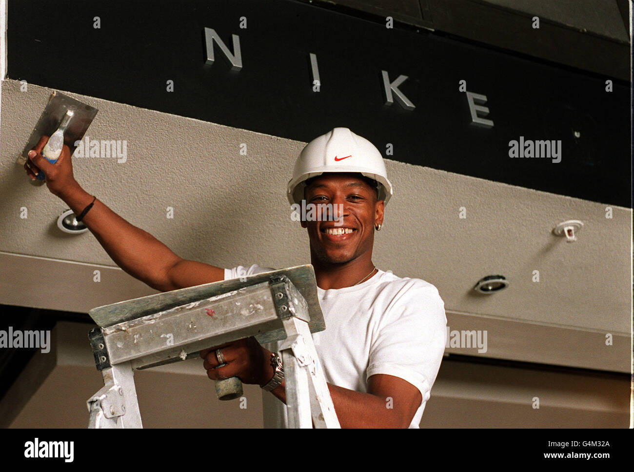 West Ham United soccer star and television presenter Ian Wright during a photocall in London where he put the finishing plasterork touches to NikeTown, which opens on July 17. Stock Photo