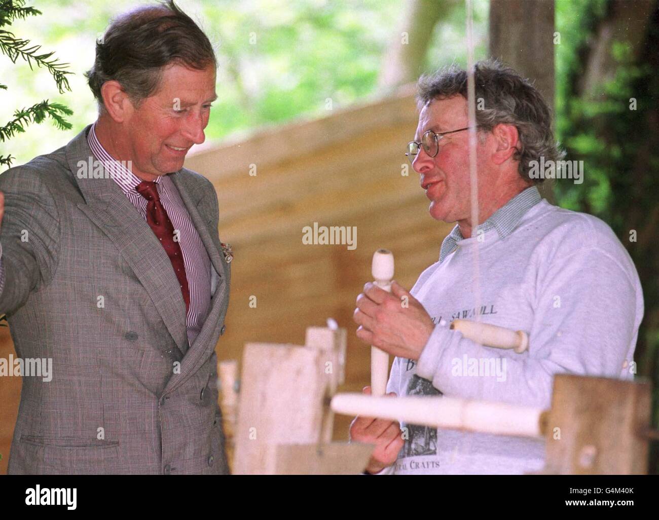 Prince of Wales is instructed in making a wooden spurtle, for stirring porridge, by Ken Grieve whilst on a visit to Woodschool Ltd in Ancrum, Roxburghshire, Scotland. * Woodschool is a working initiative aimed at demonstrating sustainable development through matching local hardwoods with furniture designers and makers. Stock Photo