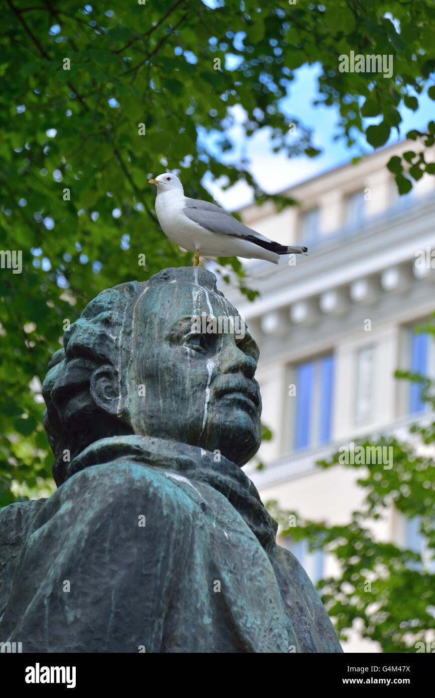 A seagull standing on the statue of Eino Leino in Helsinki, Finland. Stock Photo