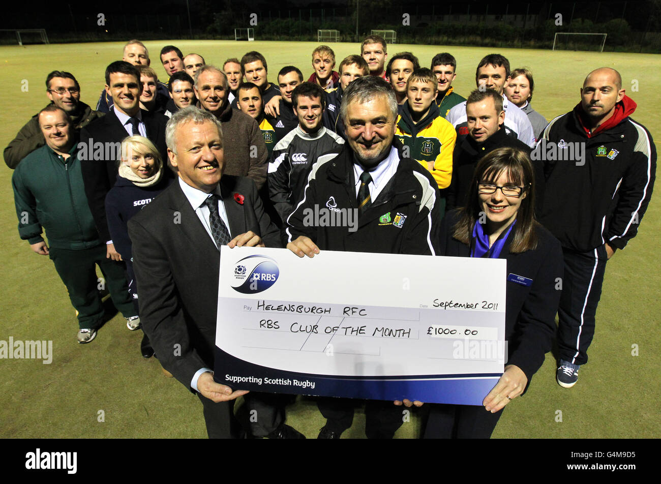 (left-right) Ed Crozier (Glasgow North Scottish Rugby Council representative) hands a cheque to Helensburgh Rugby Club President Jon Simmons with local Royal Bank of Scotland rugby representative Catriona McArthur after the club won RBS club of the month for September during a photocall at Helensbrugh Rugby Club, Helensbrugh. Stock Photo