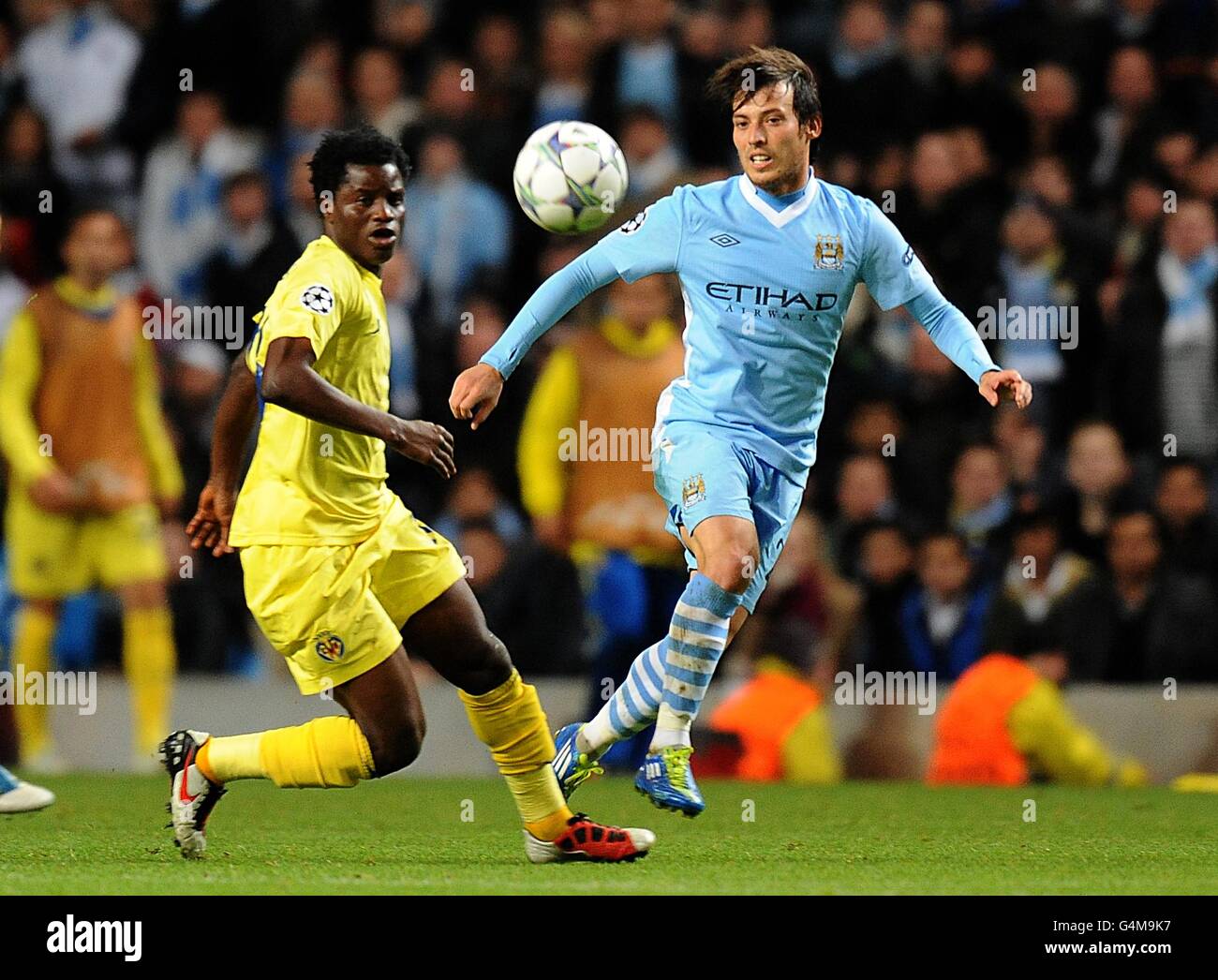 Manchester City's David Silva (right) and Villareal's Wakaso Mubarak Stock Photo