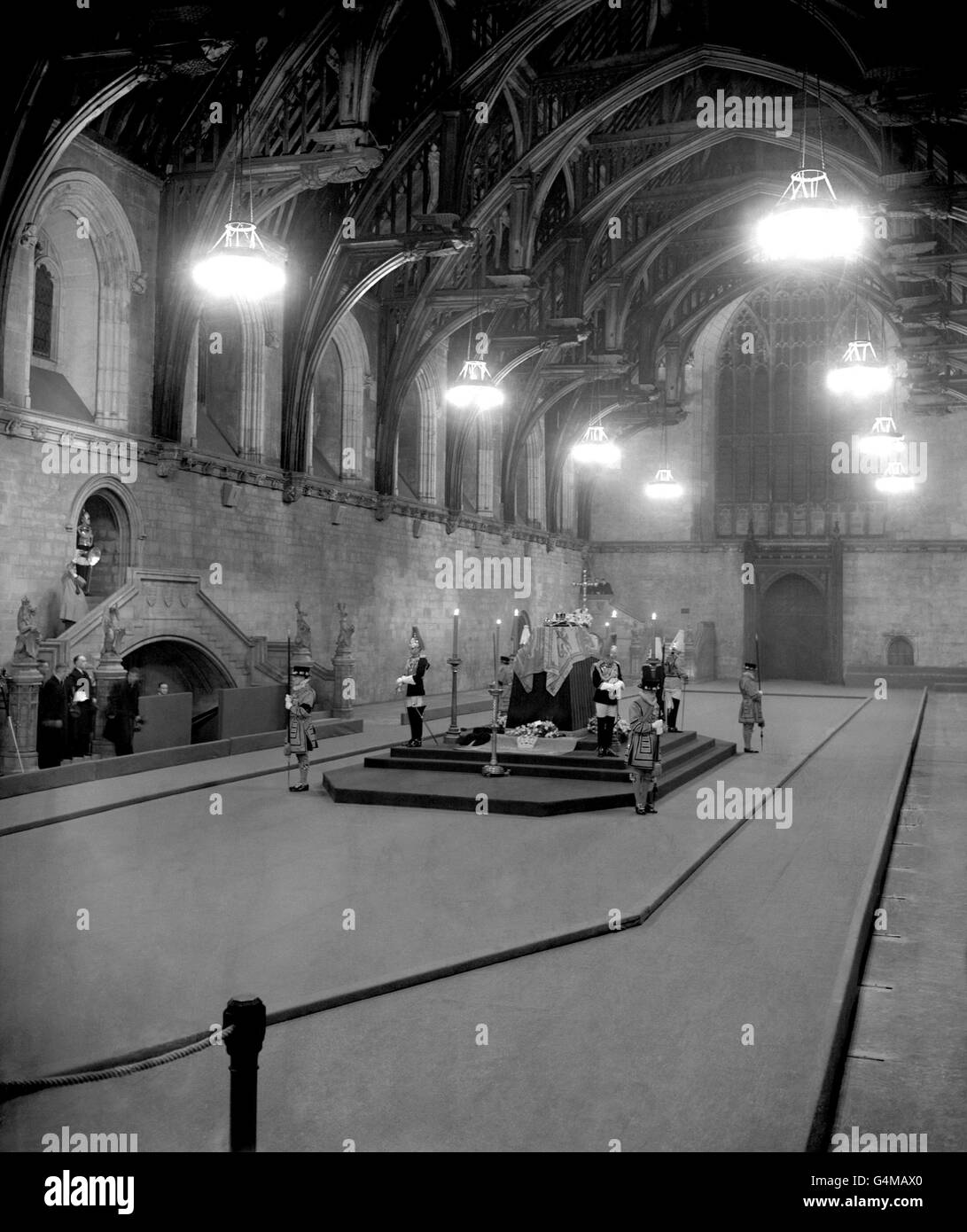 The scene in Westminster Hall, London of the lying in state of King George VI. The guard of four officers of the Household Troops, four of the Household Troops, four of the King's Bodyguard of the Yeoman of the Guard and two members of the Honourable Corp of Gentlemen-at-Arms will be maintained continuously until the funeral. Stock Photo