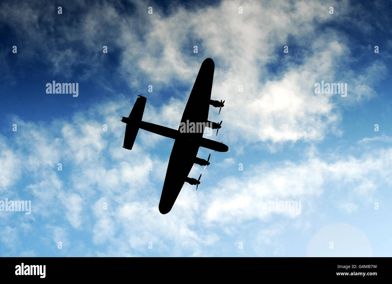A Lancaster bomber from the Battle of Memorial Flight flies over York Minister during an Anglo/French flypast following a memorial service at York Minster, for the inauguration of a memorial stone commemorating the French airmen based in York, who fought with RAF Bomber Command in WWII. Stock Photo