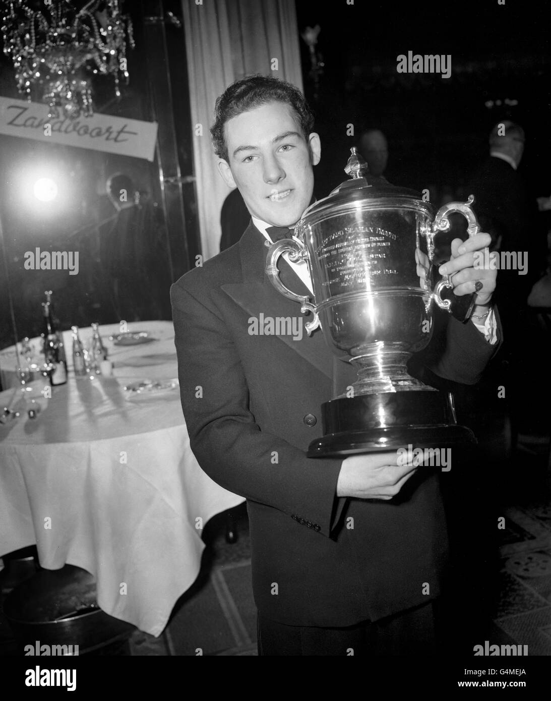 21-year old racing driver Stirling Moss holds the Richard Seaman Trophy. He won the trophy for the top British driver gaining the greatest number of points in foreign races Stock Photo