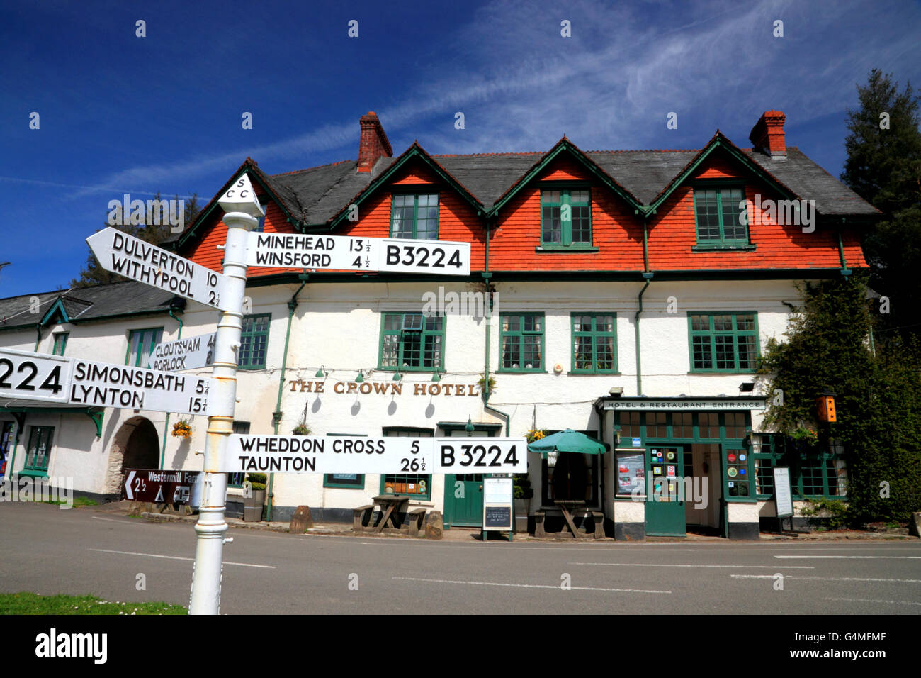 A country inn 'The Crown Hotel' and a cast iron Somerset County Council signpost. Stock Photo