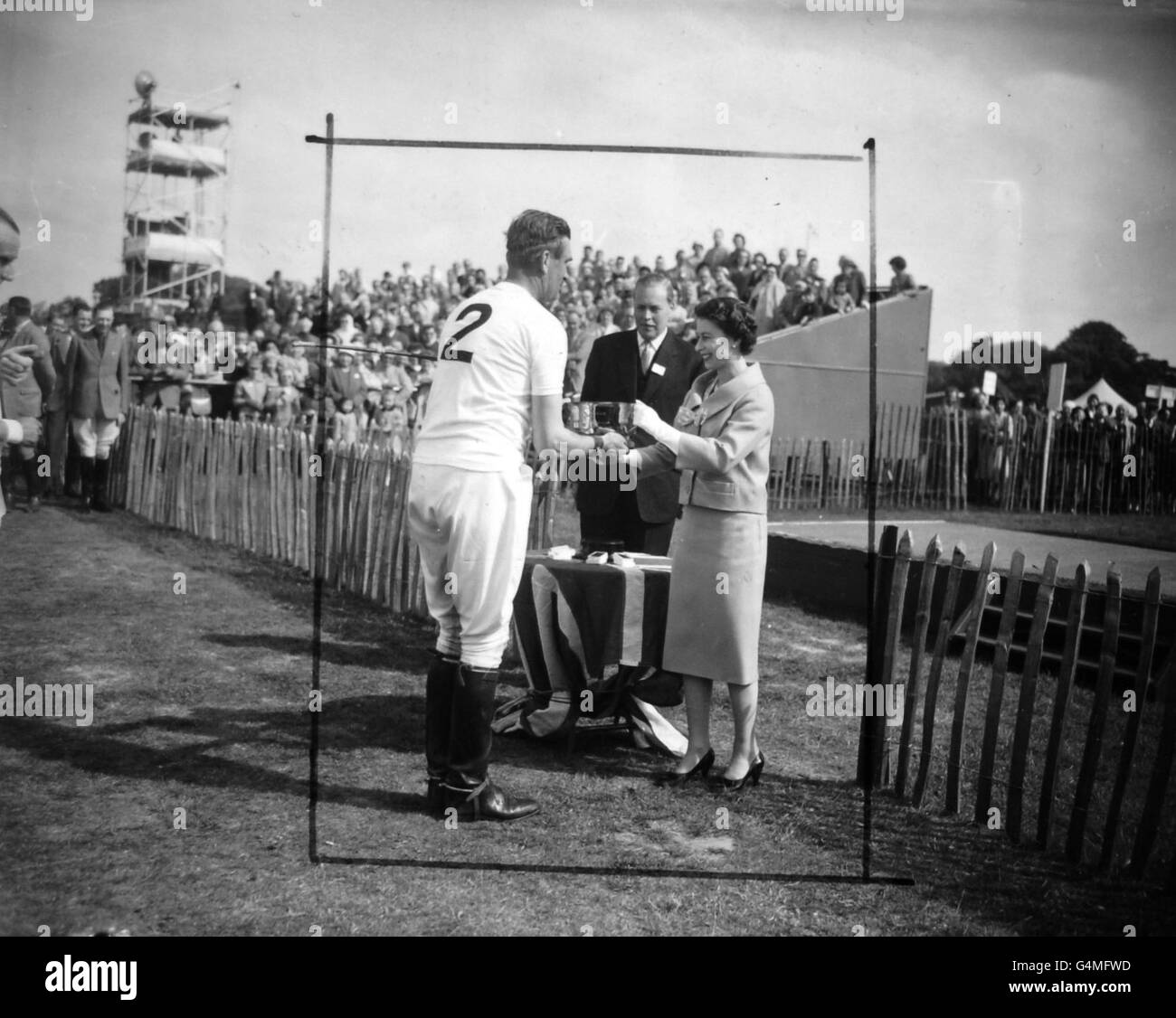 Queen Elizabeth II presents the Royal Windsor Horse Show Challenge Cup to Lieutenant-Colonel A.F Harper, captain of Cowdray Park polo team who had just beaten the Duke of Edinburgh's Windsor Park side at Smith's Lawn, Windsor Great Park. Stock Photo