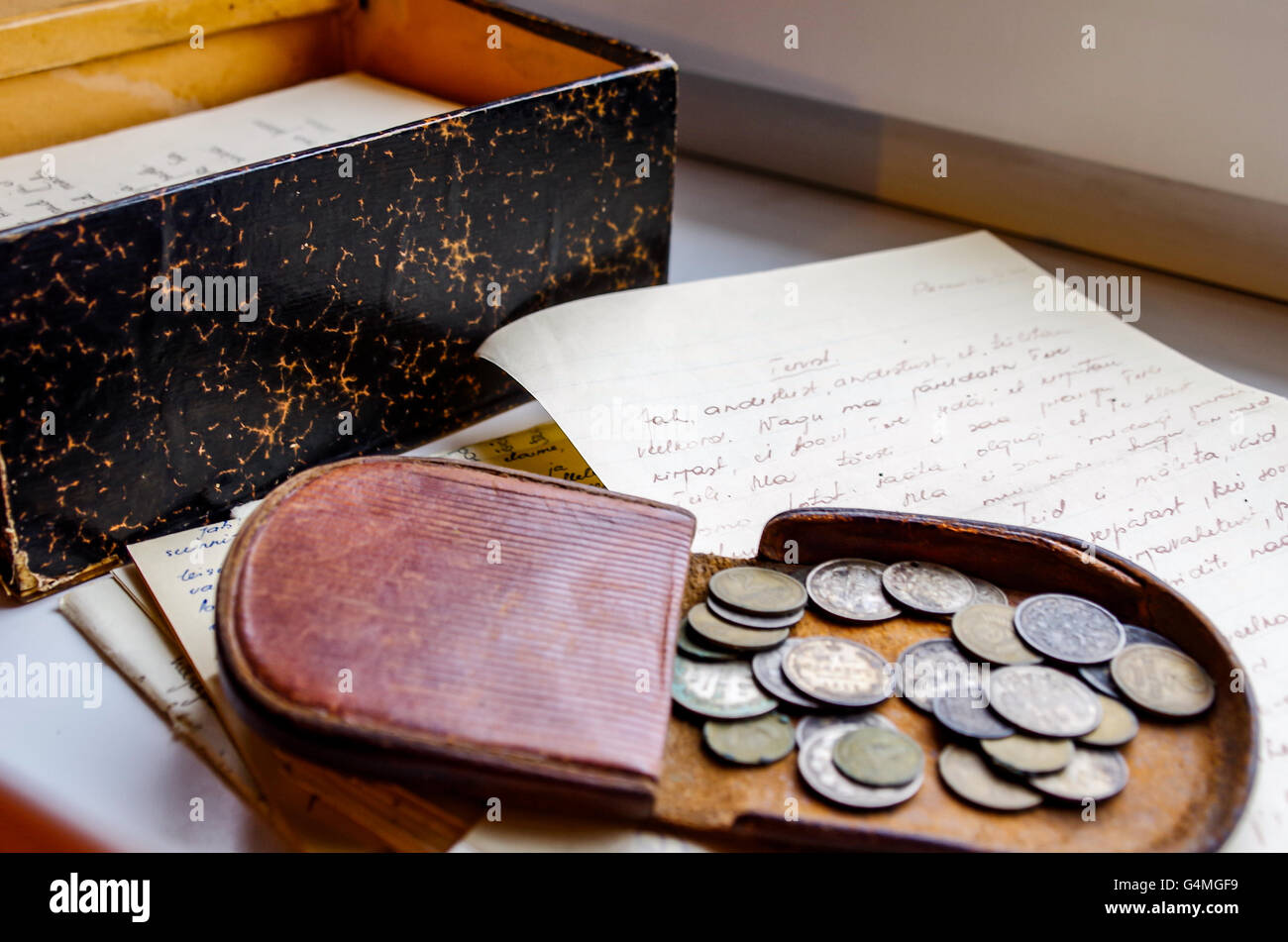 Leather coin pouch with coins from Russian Empire and a box of handwritten love letters from 2nd World War era Stock Photo
