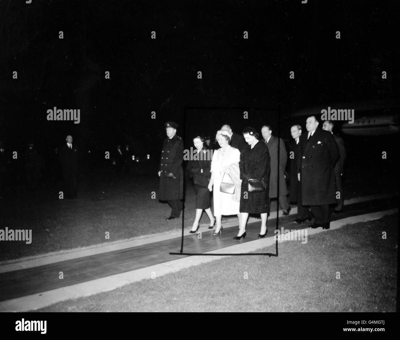 The Queen Mother walks between her daughters, Princess Margaret, left