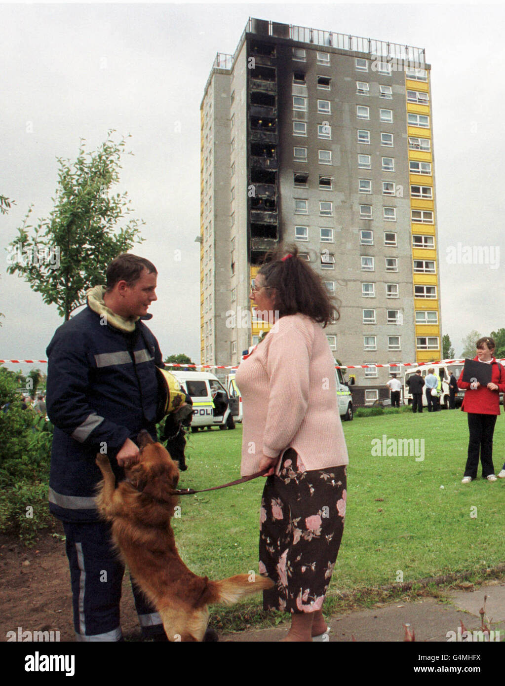 A local resident chats with a firefighter at a 14storey block of flats