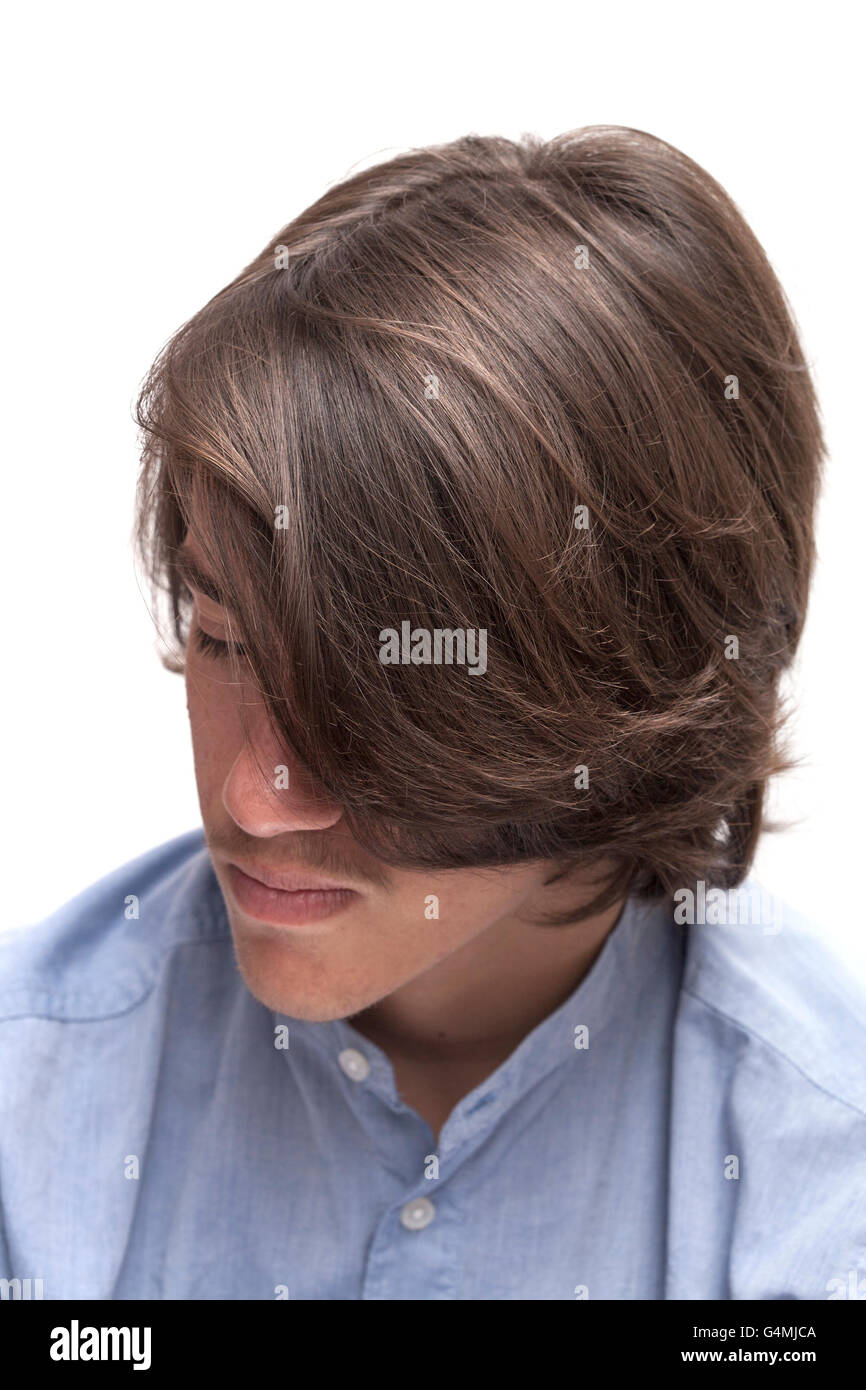 portrait of teen boy with long surfer haircut isolated on white Stock Photo