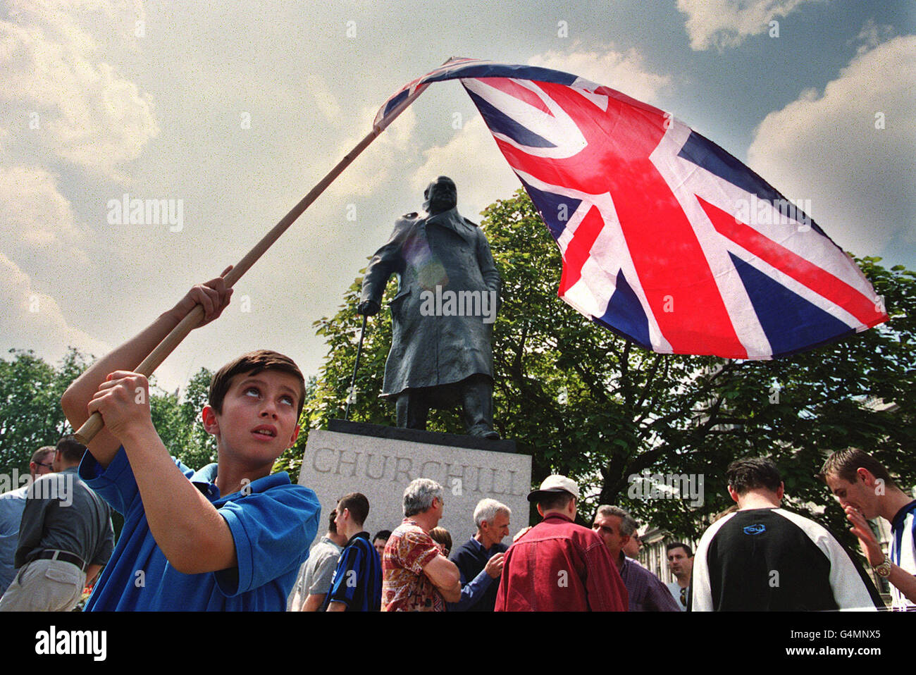 The greatest nation. Portrait of a happy young boy standing in front of the  Union Jack Stock Photo - Alamy