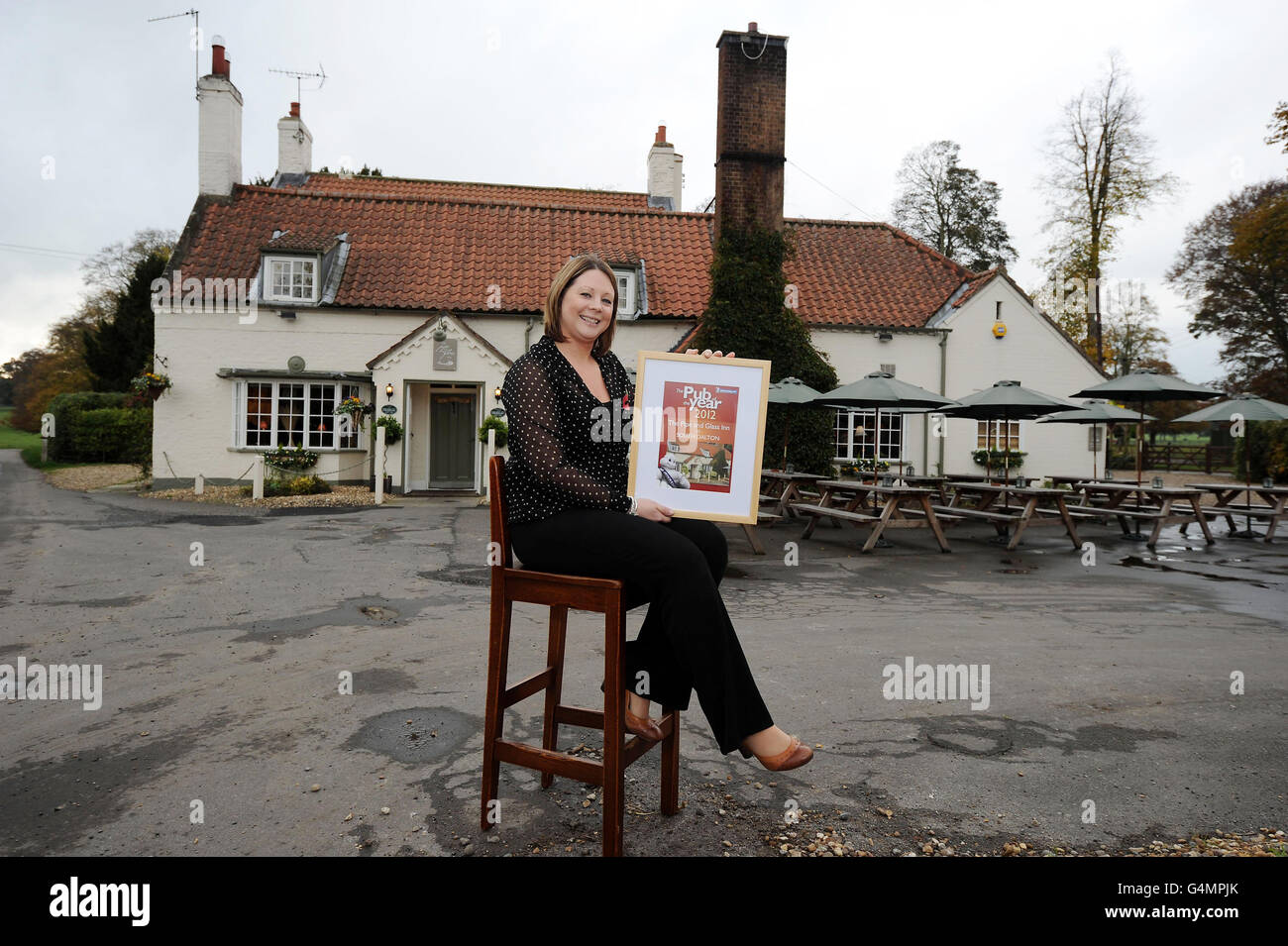 Landlady Kate Mackenzie of The Pipe and Glass Inn, South Dalton, East Yorkshire, celebrates winning the Pub of the Year Award in the Michelin Eating Out in Pubs Guide 2012. Stock Photo