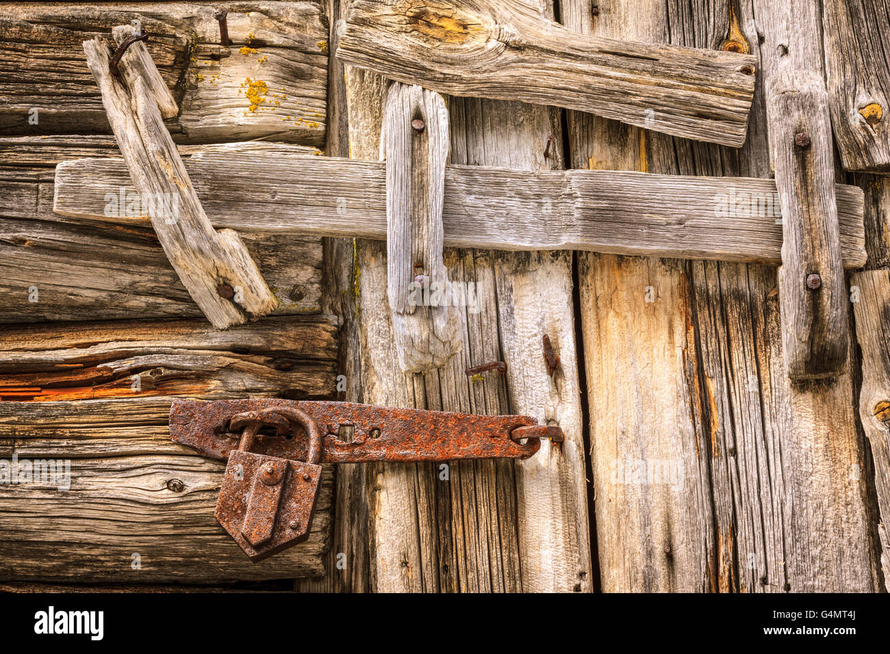 An Old Wooden Log Door Is Closed Locked And Latched With A