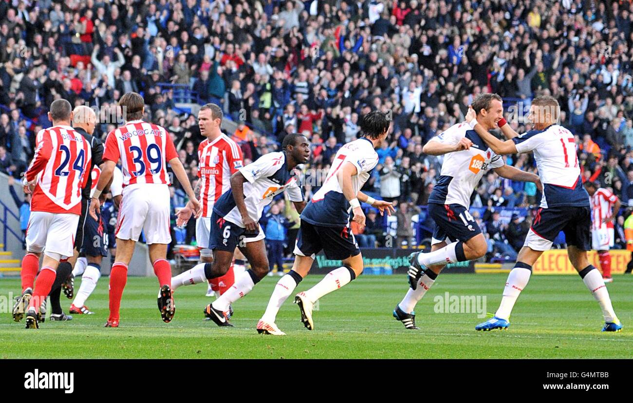 Bolton Wanderers' Kevin Davies (second right) celebrates with team-mates as Stoke City players surround match referee Howard Webb (second left, obscured) Stock Photo