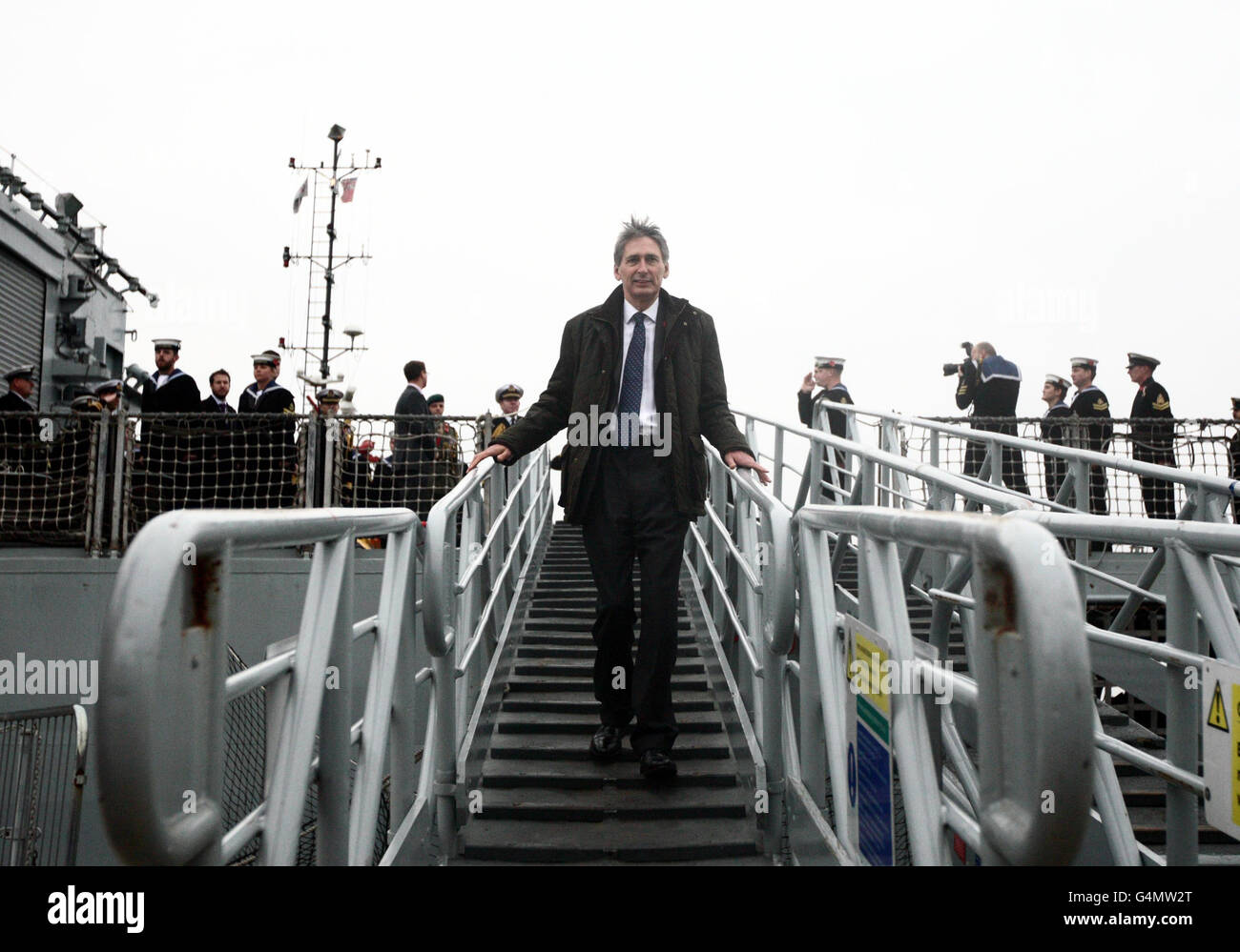 Defence Secretary Philip Hammond disembarks from HMS Liverpool as it returned to its base of Portsmouth, Hampshire, after Mr Hammond congratulated the Royal Navy for its 'momentous' role in helping defeat Gaddafi's troops in Libya. Stock Photo