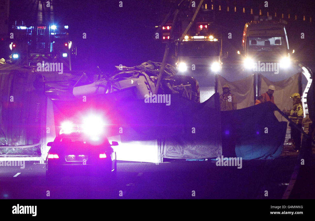 The scene on the M56 in Cheshire when a lorry plunged from a bridge onto the motorway. The lorry, which was laden with household goods, tumbled onto the west-bound carriageway at junction 11, near Preston Brook, Warrington killing the driver. Stock Photo