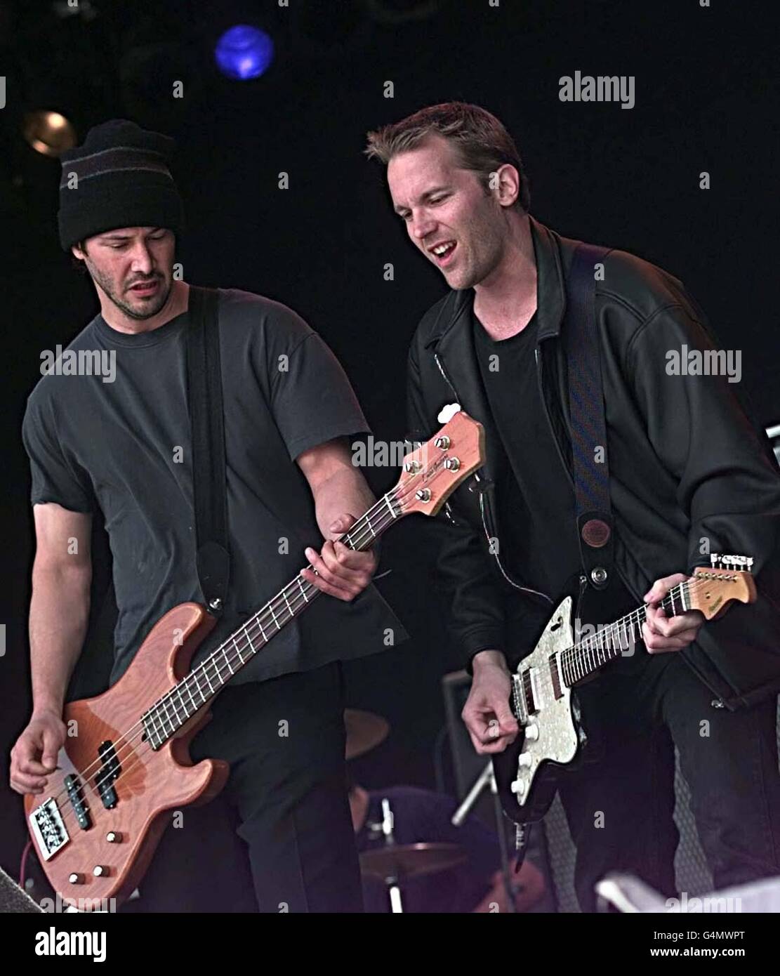 American film star Keanu Reeves (left), playing the bass guitar, on stage with his band 'Dogstar' at the Glastonbury festival. Stock Photo