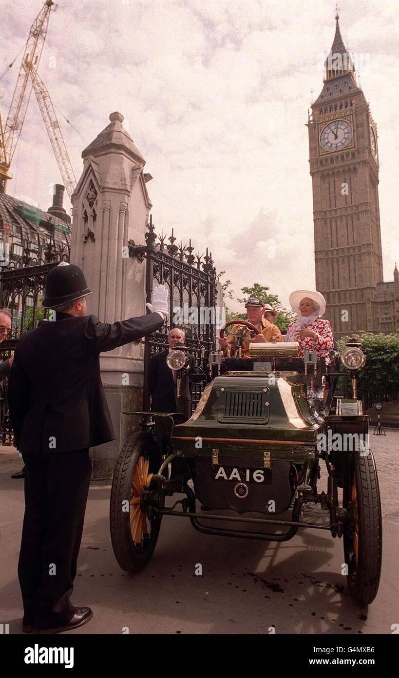 Lord Montagu of Beulieu drives into Palace yard, Palace of Westminister, with Betty Boothroyd in the passenger seat, 100 years after his father, The Hon John Scott Motagueu, was denied access to the commons driving the same car a 12hp Daimler. Stock Photo