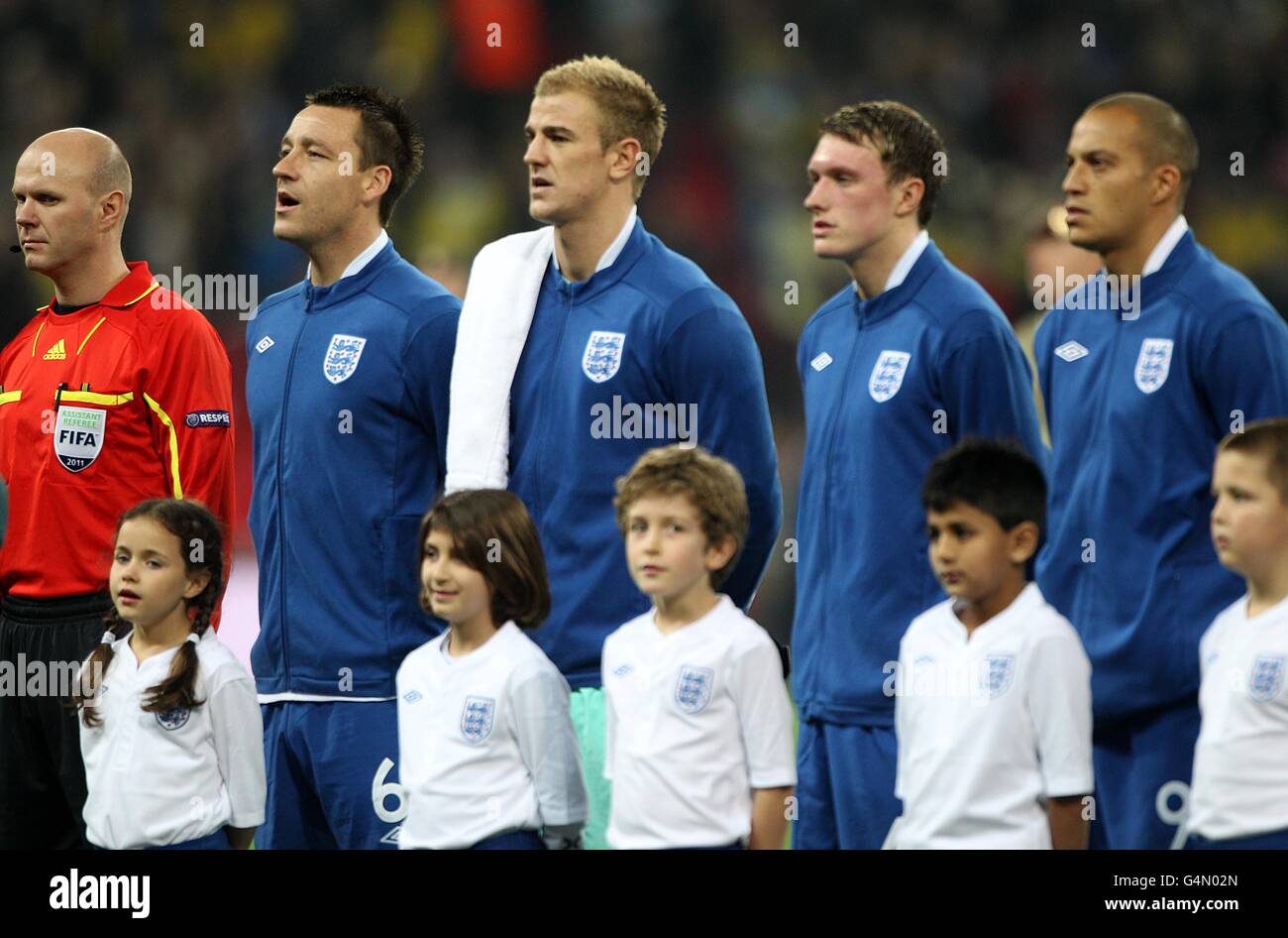 (left to right) England's John Terry, Joe Hart, Phil Jones and Bobby Zamora during the national anthem Stock Photo